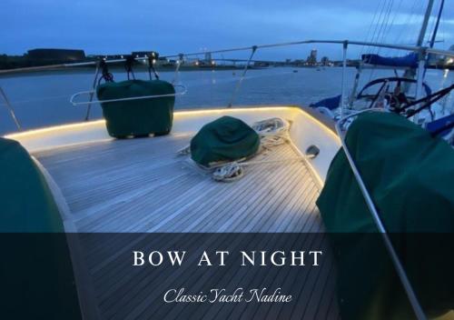 a bow of a boat with a green hat on it at Classic Yacht Nadine in Poole Harbour, Dorset, with a Hot Tub Jacuzzi in Poole