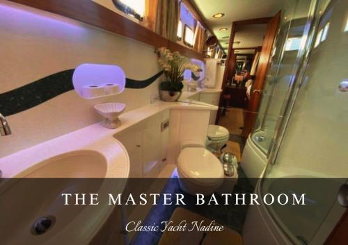 a master bathroom with a sink and a shower at Classic Yacht Nadine in Poole Harbour, Dorset, with a Hot Tub Jacuzzi in Poole