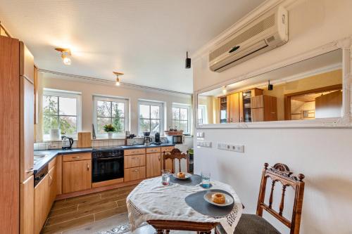 a kitchen with a table and chairs in a room at Ferienwohnung Krakow am See in Krakow am See