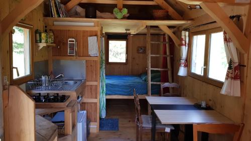 a kitchen and dining area of a tiny house at La basse Molune in La Pesse