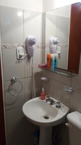 ein Badezimmer mit einem Waschbecken und einem Telefon an der Wand in der Unterkunft Departamentos San Francisco in San Francisco