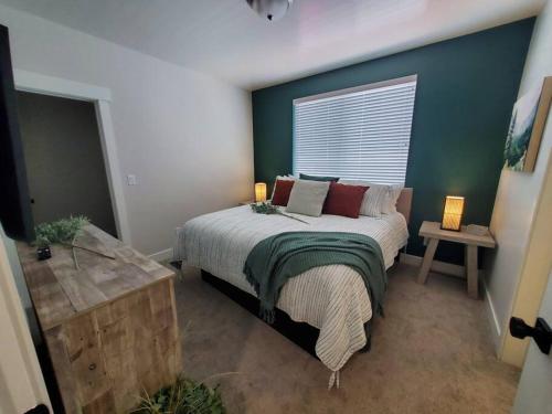 a bedroom with a bed with two lamps and a window at Monroe Mountain Suite - Castle Rock Condos in Richfield