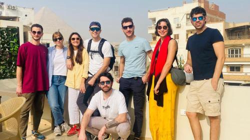 a group of people wearing sunglasses posing for a picture at Carpet Alaadein Pyramids view in Cairo