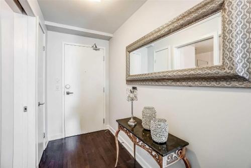 a room with a table and a mirror on the wall at Downtown Apartments 16 in Toronto