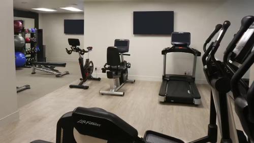 a gym with several treadmills and exercise bikes at Embassy Suites by Hilton Los Angeles International Airport South in El Segundo