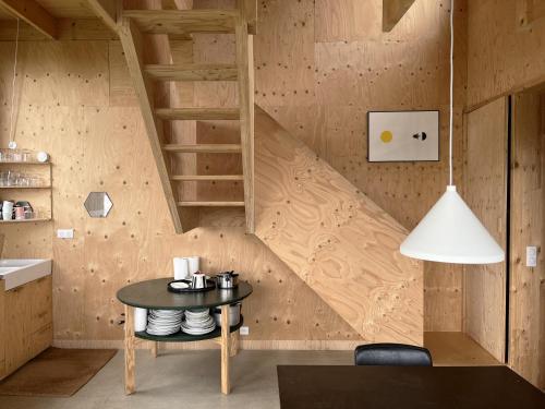 a room with a table and a wooden staircase at Beautiful wood house and view in Audierne