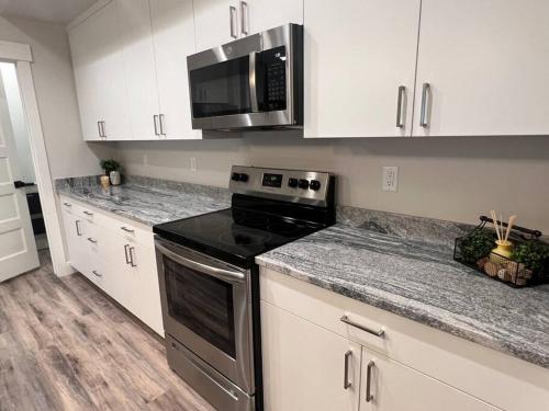 a kitchen with a stove and a microwave at Aspen Heart Suite - Castle Rock Condos in Richfield