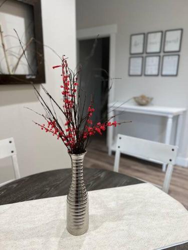 a vase with red flowers in it sitting on a table at Aspen Heart Suite - Castle Rock Condos in Richfield
