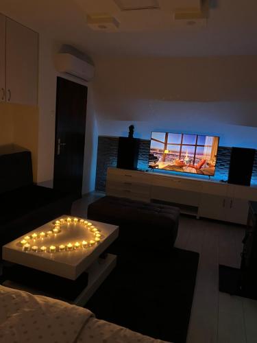 a living room with a couch and a flat screen tv at Vikendica Uvac in Priboj