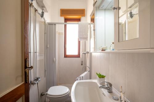 ein Bad mit einem Waschbecken und einem WC in der Unterkunft The Sunrise Attico Panoramico in Porto Cesareo
