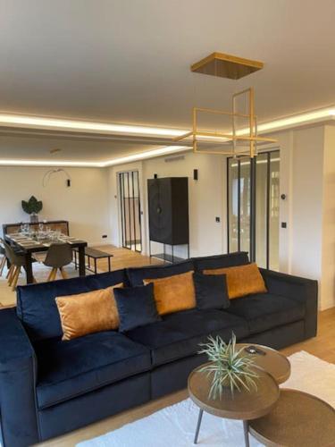 a living room with a blue couch and a table at Maison Villa in Vitry-sur-Seine