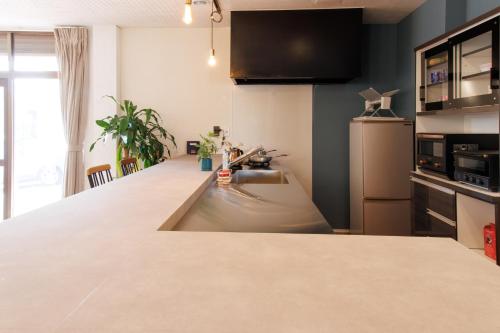 a kitchen with a sink and a counter top at Quilotoa Mifune Guesthouse in Mifune
