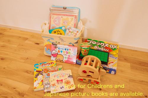 a bunch of childrens toys and books on the floor at Quilotoa Mifune Guesthouse in Mifune