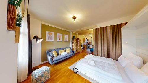 uma sala de estar com uma cama e um sofá em CozyHome Markkleeberg Mitte (inkl. Netflix) em Markkleeberg