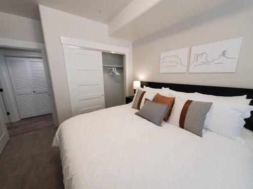 a bedroom with a large white bed with pillows at Red Rock Suite - Castle Rock Condos in Richfield
