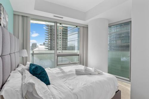 a bedroom with a large bed and a large window at Downtown Apartments 18 in Toronto