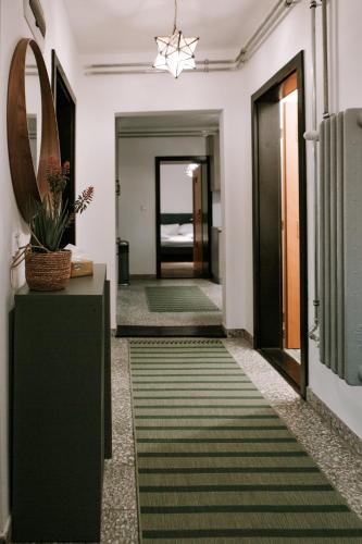 a hallway with a green rug on the floor at Csongor Lak in Igricetanya