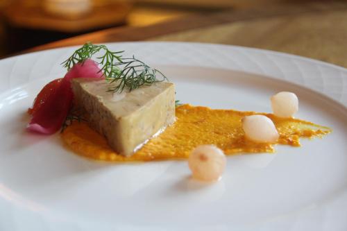a white plate with a piece of food on a plate at Skjoldenæsholm Slot in Jystrup