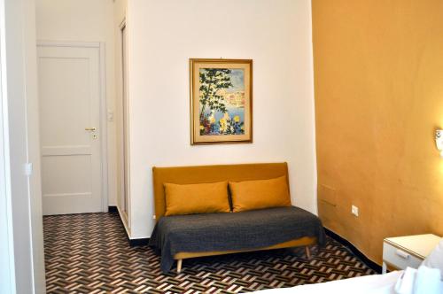 a couch in a room with a painting on the wall at Giramondo in Rapallo