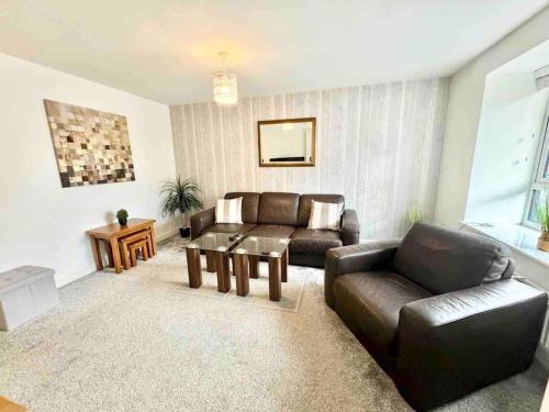 a living room with a couch and a table at Folkestone 3 Bedroom Home just off M20, great area in Kent