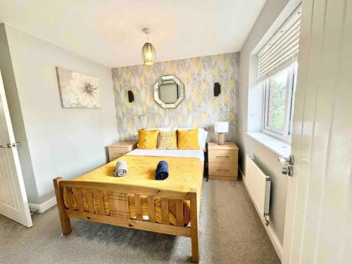 a bedroom with a large bed and a mirror at Folkestone 3 Bedroom Home just off M20, great area in Kent