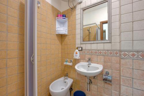 a bathroom with a sink and a mirror at Casa Athena - Goelba in Portoferraio