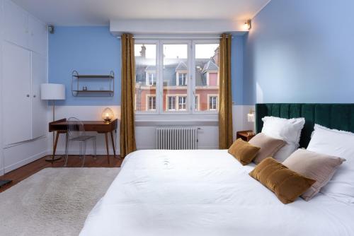 un grand lit blanc dans une chambre avec une fenêtre dans l'établissement Spacieux 4 chambres - Hyper Centre-ville, à Amiens