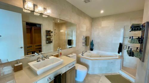 a bathroom with two sinks and a mirror and a tub at 09I Jungle/Ocean View to thrill Nature Enthusiasts in Panama City