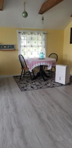 a dining room with a table and two chairs at Sunshine in Gouldsboro
