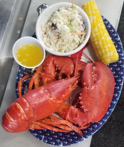 a plate with lobster and rice and a bowl of corn at Sunshine in Gouldsboro