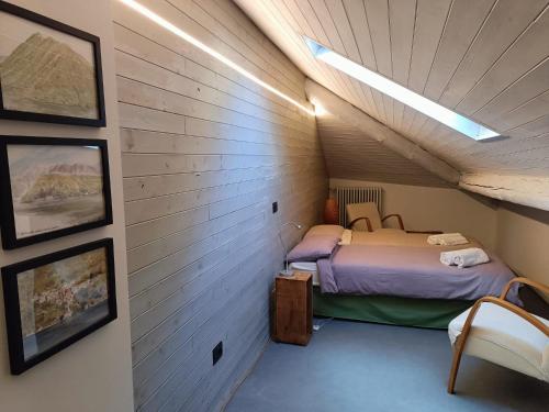 a small room with a bed in a attic at Piazzetta House Stunning Lake View Welcome Cocktail at Il Baretto in Moltrasio
