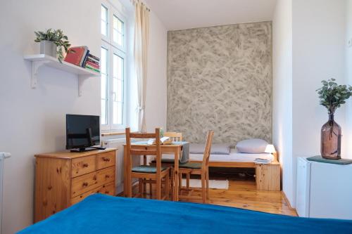 a room with a table and chairs and a desk at U staré cesty in Horní Slavkov