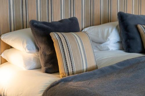 a couch with pillows on top of it at The Pier Hotel in Harwich
