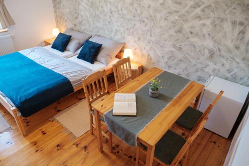 a bedroom with a bed and a dining room table at U staré cesty in Horní Slavkov