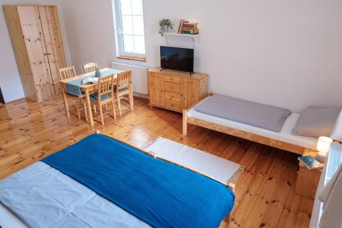 a room with a bed and a table and a couch at U staré cesty in Horní Slavkov