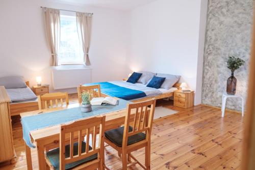 a bedroom with a bed and a table and chairs at U staré cesty in Horní Slavkov