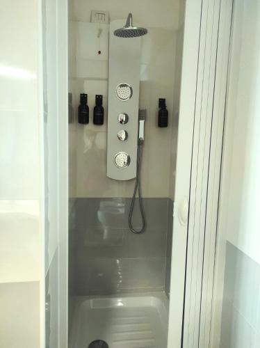 a small bathroom with a shower with a toilet at Michelangelo Airport Suite Room in Fiumicino