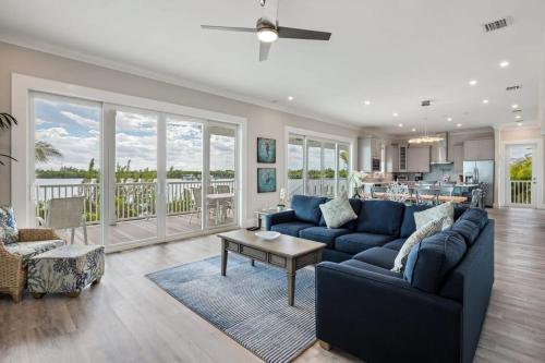 a living room with a blue couch and a table at Mastway House -Pool & Dock! in Key West