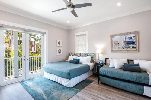a bedroom with two beds and a window at Sophisticated Sunsets by Brightwild-Pool & Dock! in Key West