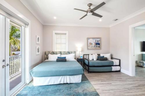 a bedroom with a bed and a couch and a ceiling fan at Mastway House -Pool & Dock! in Key West