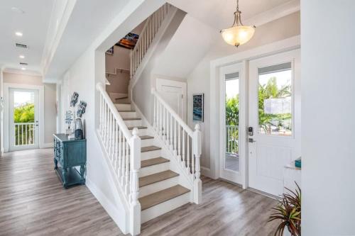 a white staircase in a home with white walls at Mastway House -Pool & Dock! in Key West