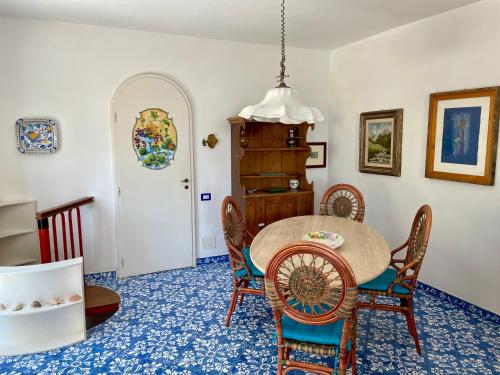 a dining room with a table and chairs at La Cuchina in Capri