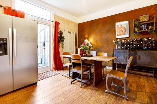 a kitchen with a table and a refrigerator at Room with a view Catford, homestay in Hither Green