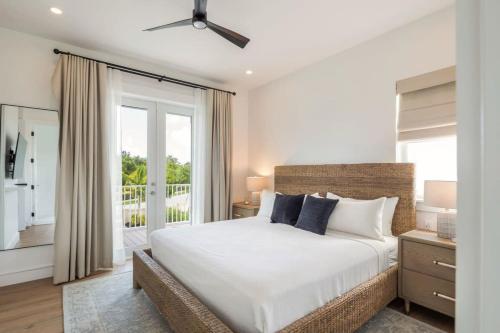 a bedroom with a large bed and a balcony at The Crestwood House - Private Heated Pool & Parking in Key West