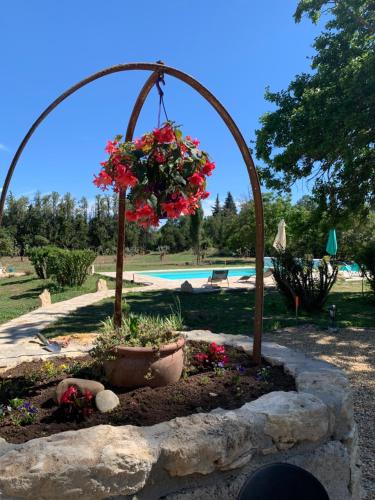 a flower arrangement in a garden in front of a pool at La Miougrano in Plan-dʼOrgon