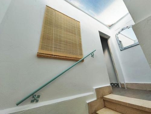 a stairway with a window and a stair railing at Apartamento PUERTA DE CÓRDOBA in Carmona