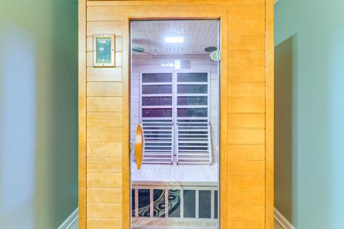 a wooden door with a window in a room at Pet-Friendly Hiawassee Cabin with Lake Views and Sauna in Hiawassee