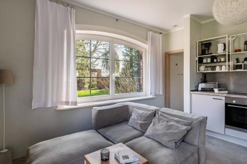 a living room with a couch and a large window at Ferienwohnung Fünf in Saal