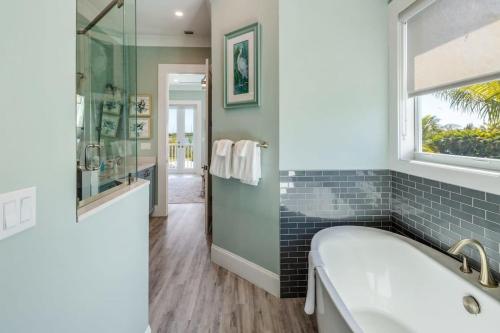 a bathroom with a tub and a window at Waterlane House -Pool & Boat Dock in Stock Island