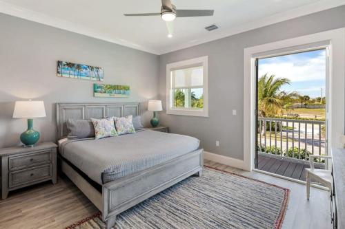 a bedroom with a bed and a balcony at Coastal Chic by Brightwild-Pool & Boat Dock in Stock Island